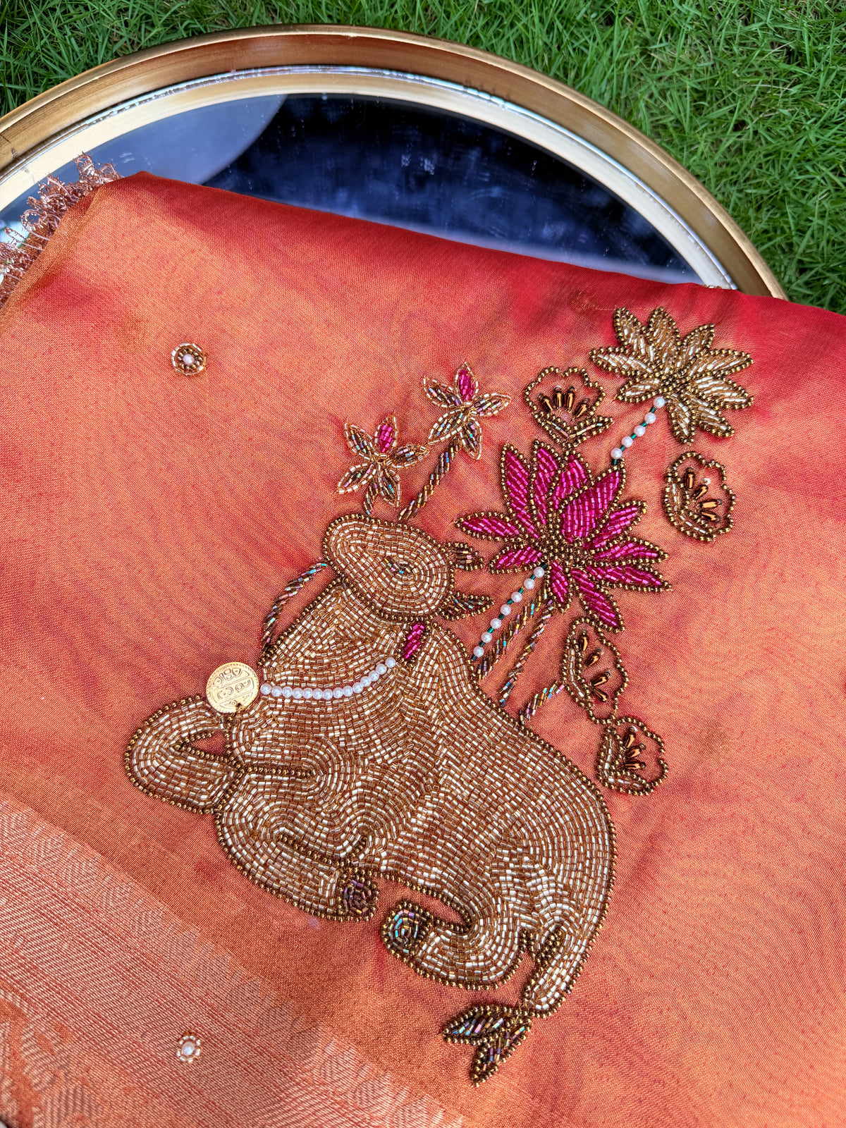 Peach Coral Organza Saree with Intricate Cow Motif & Cutwork Border Embroidery