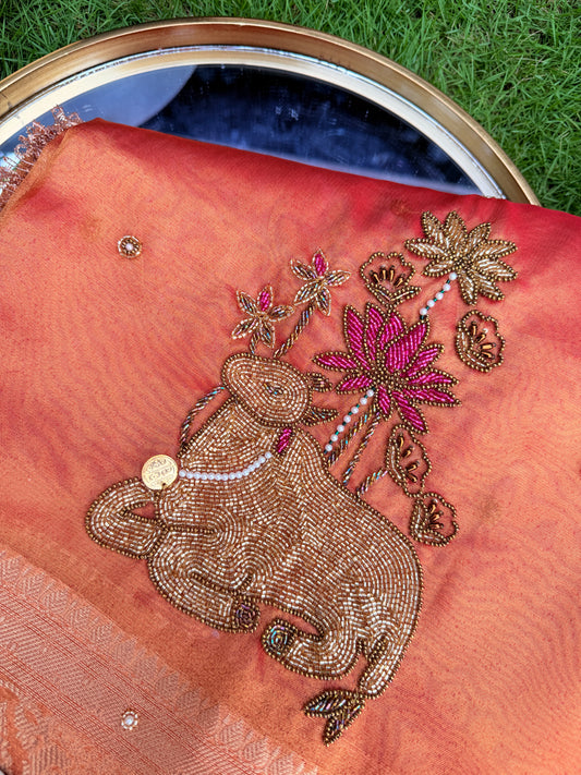 Peach Coral Organza Saree with Intricate Cow Motif & Cutwork Border Embroidery