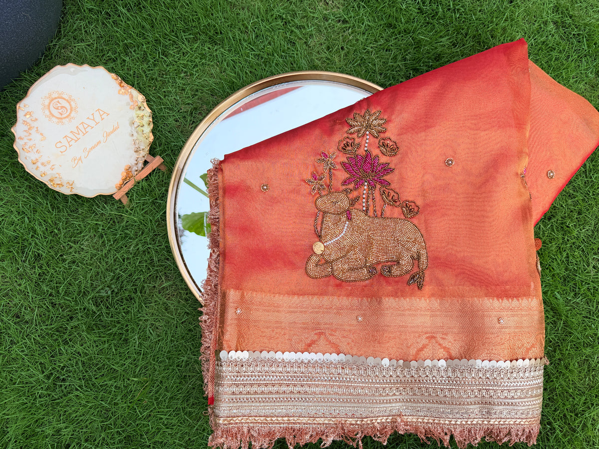 Peach Coral Organza Saree with Intricate Cow Motif & Cutwork Border Embroidery